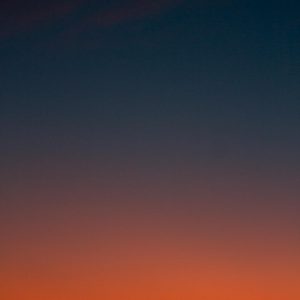Crescent moon and fiery orange sunset horizon